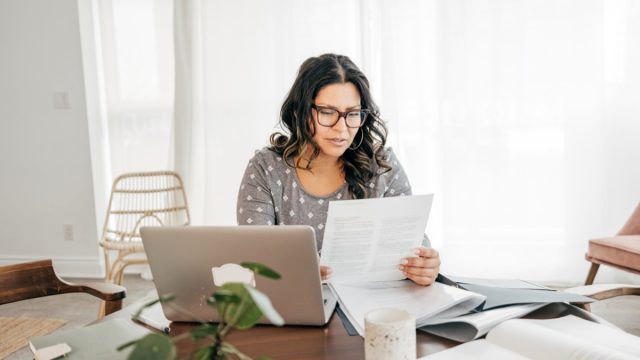 woman working from home with taxes