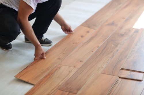 Close up of person installing laminate flooring