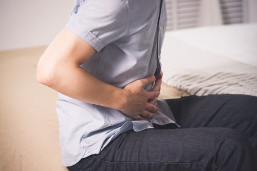 man with abdominal pain suffering at home