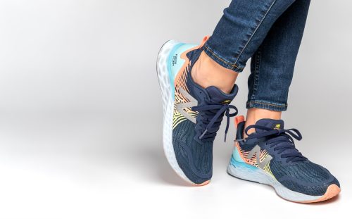 Close up of a woman's ankles and feet wearing jeans and New Balance Fresh Foam sneakers