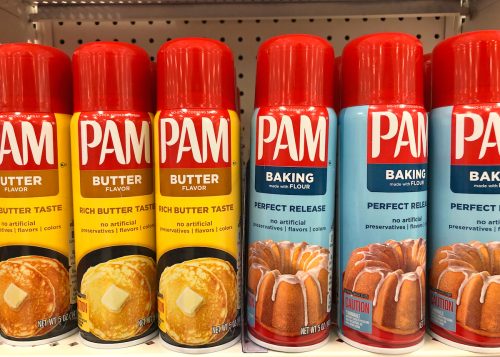 A display of Pam cooking spray on a store shelf.