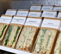 Pre-made sandwiches in packages sitting in a fridge