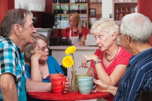 group of older people gossiping at a restaurant