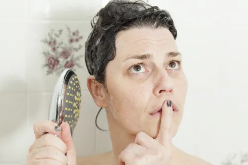 woman having an onslaught of shower thoughts while washing her hair