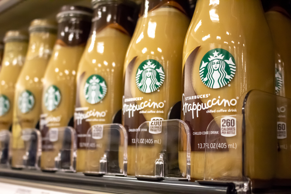 A close-up of Starbucks Frappuccino bottled coffee drinks on a grocery store shelf