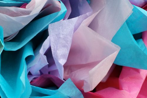 Close-up of pink, purple, and blue tissue paper for gift wrapping