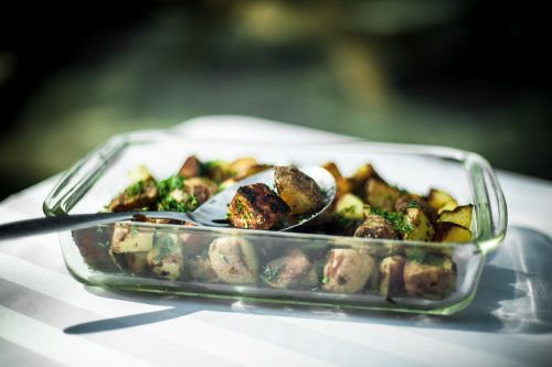 Roasted potatoes and vegetables in a pyrex dish