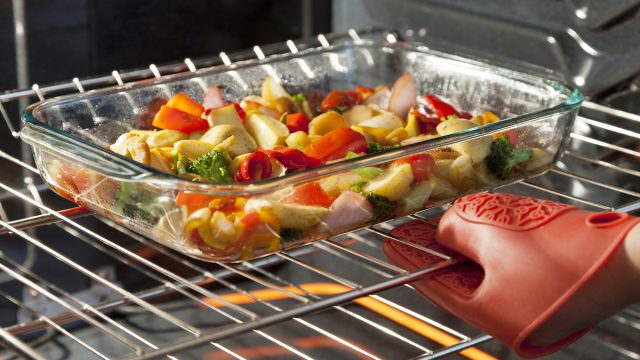 Fresh vegetables roasting in a clear dish in the oven