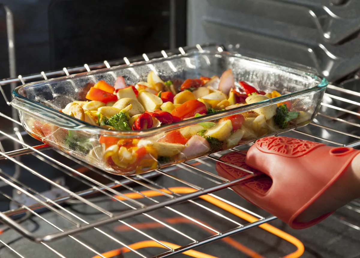 https://bestlifeonline.com/wp-content/uploads/sites/3/2023/02/vegetables-roasting-glass-dish-in-oven.jpg?quality=82&strip=all