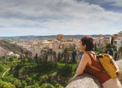 Horizontal view of unrecognizable woman with backpack on holidays looking at the ancient Spanish city of Cuenca.