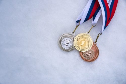 Gold silver and bronze medal, white snow background.