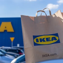 paper shopping bag on car roof in front of IKEA store