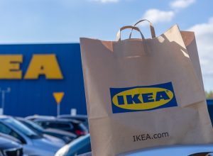 paper shopping bag on car roof in front of IKEA store