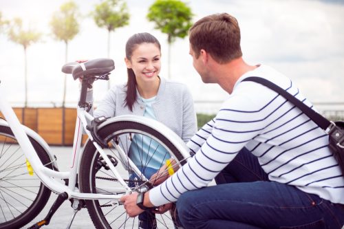 Man Helping Woman with Bike