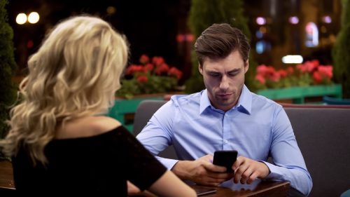 Man on His Phone While on a Date