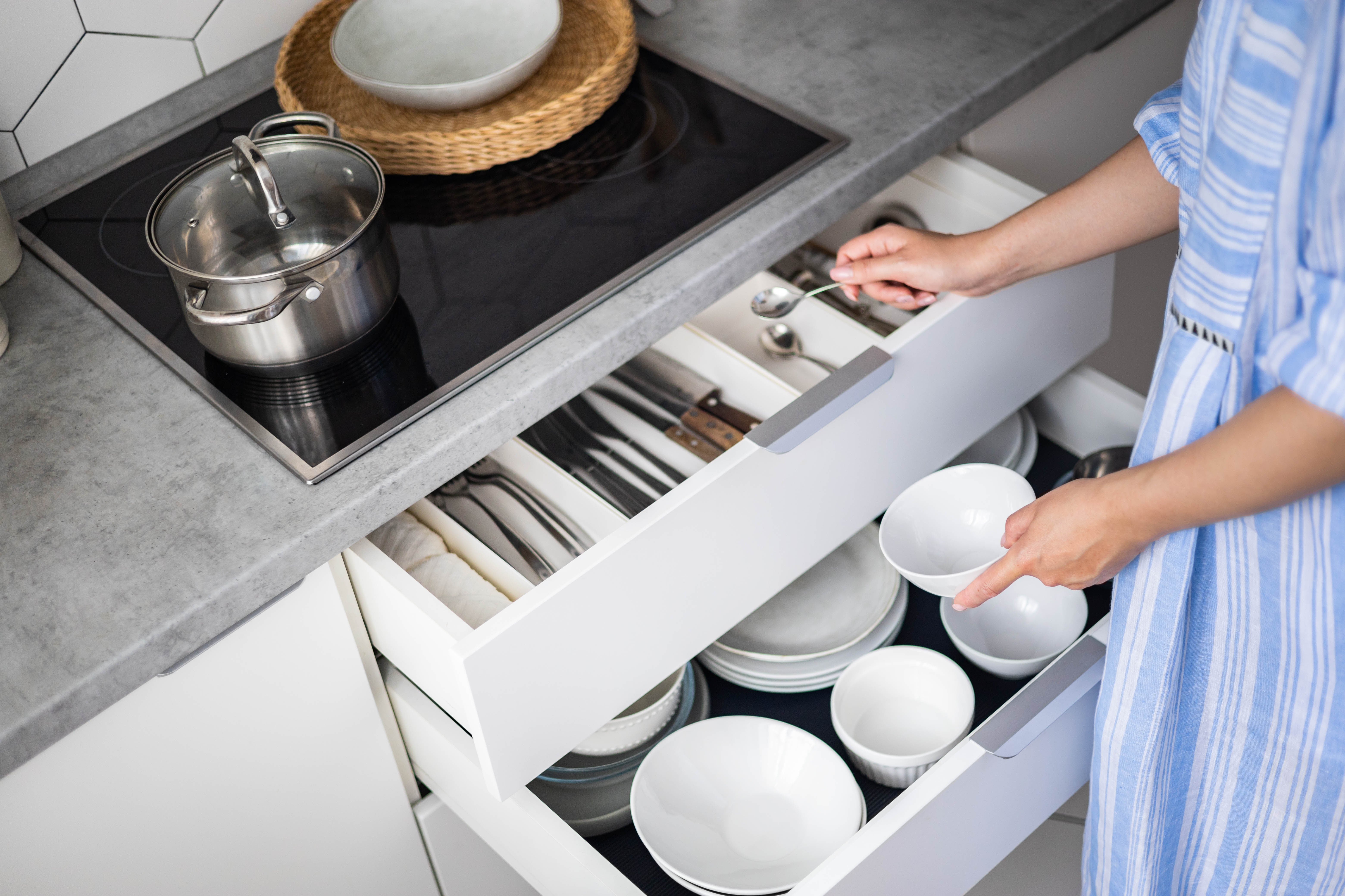 Woman putting away dishes