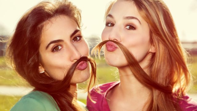 Two Girls Using their Hair as Mustaches