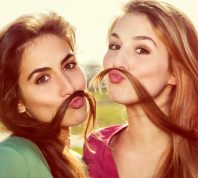 Two Girls Using their Hair as Mustaches