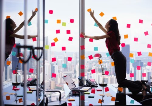 Woman with Window full of Post-Its