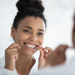 Young Woman Flossing her Teeth
