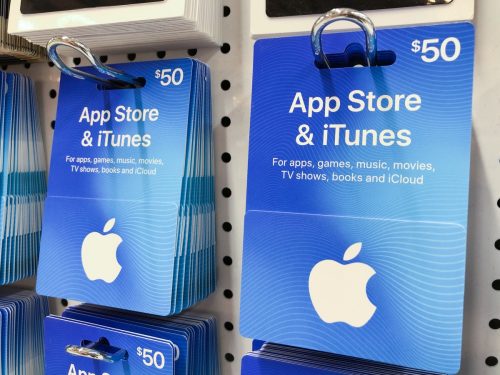 Apple App Store and iTunes gift cards on store shelf. A gift card is a prepaid card issued by a retailer to be used for purchases within a particular store.