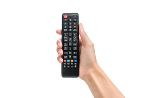 person holding a universal remote