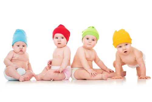 four babies in different colored hats on a white background