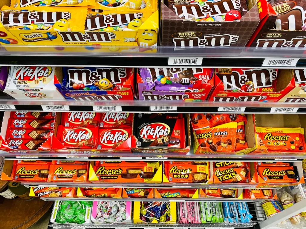 Various chocolate candy for sale inside a convenience store, top down view.