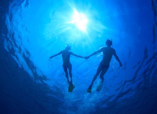 couple swimming underwater together