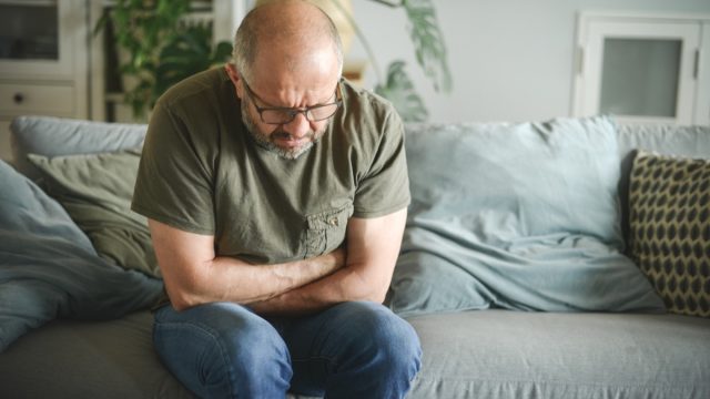 Mature adult man with stomach bug
