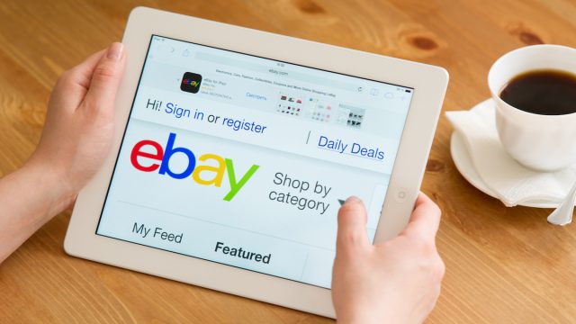 Close up of a person using an iPad to shop on eBay