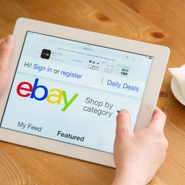 Close up of a person using an iPad to shop on eBay
