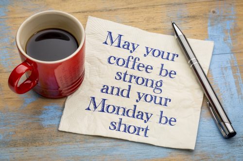 a cup of coffee with a napkin containing a funny, motivation motivation quote