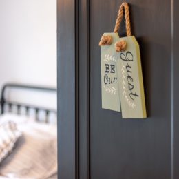 Guest bedroom with 'be our guest' sign on door