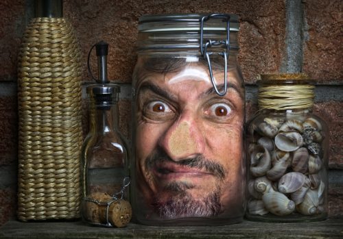 surrealistic image of a man's head in a jar