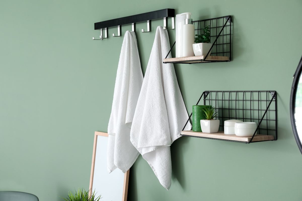 Modern interior of stylish bathroom with towels on hooks