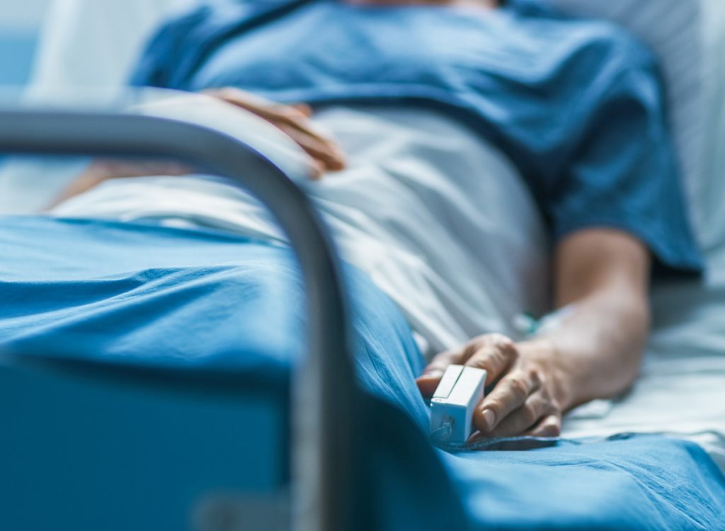 A person lying in a hospital bed