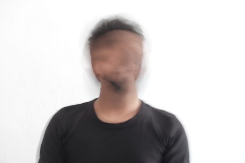 image of a man with a blurred face