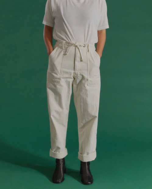 Model wearing neutral canvas work pants from IJJI