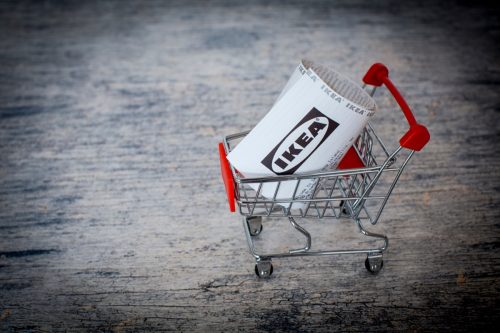 Mini supermarket trolley cart with Ikea receipt. Ikea is a furniture retail company that sells furniture, kitchen appliances and home accessories.