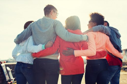 group of people with their arms around one another