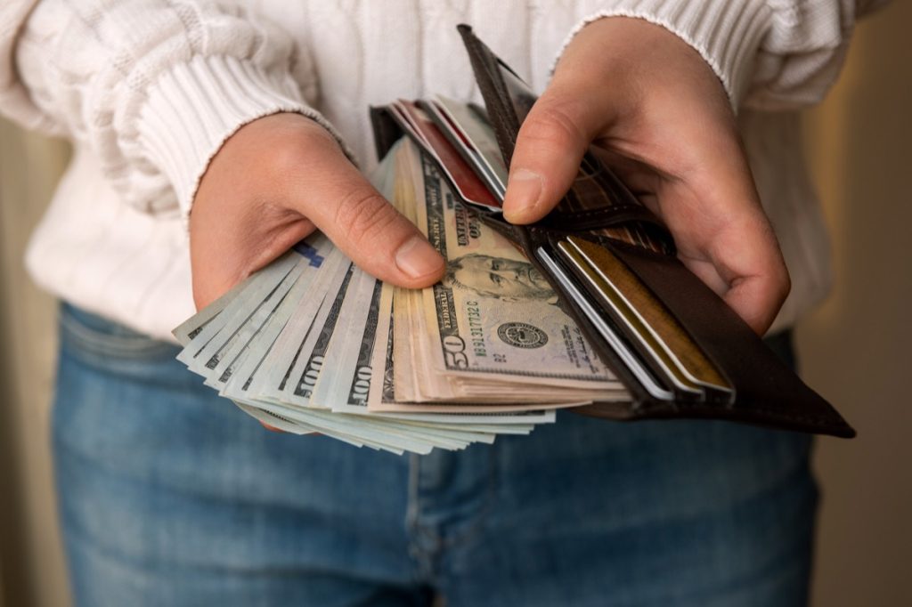 Man counting the money spread of cash in wallet