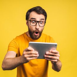 man looking surprised while reading weird body facts on his phone