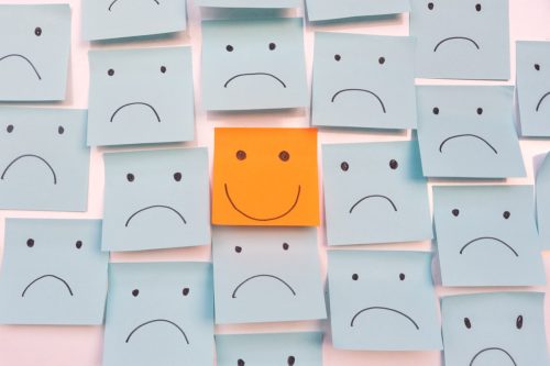 a smile face written on a post-it note surrounded by safe faces