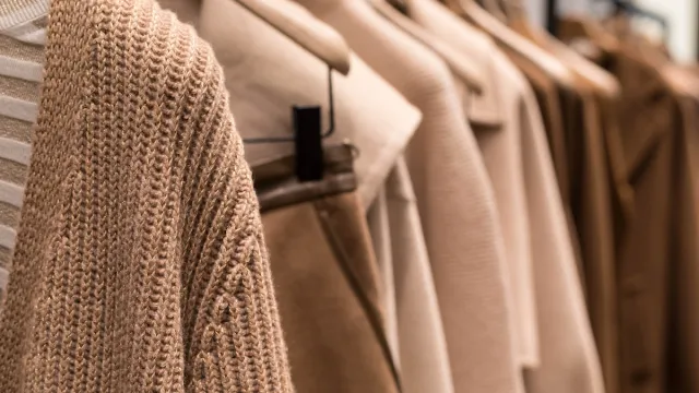 Coat,And,Sweater,Light,Brown,On,The,Hanger,In,The