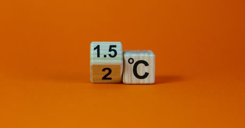 Symbol for limiting global warming: turned cube with '2 C' to '1.5 C' printed on face