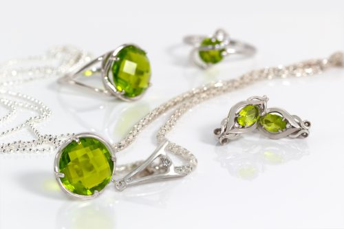 A Peridot jewelry set against a white background