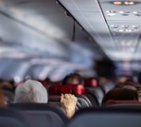 man holding airplane seat turbulence