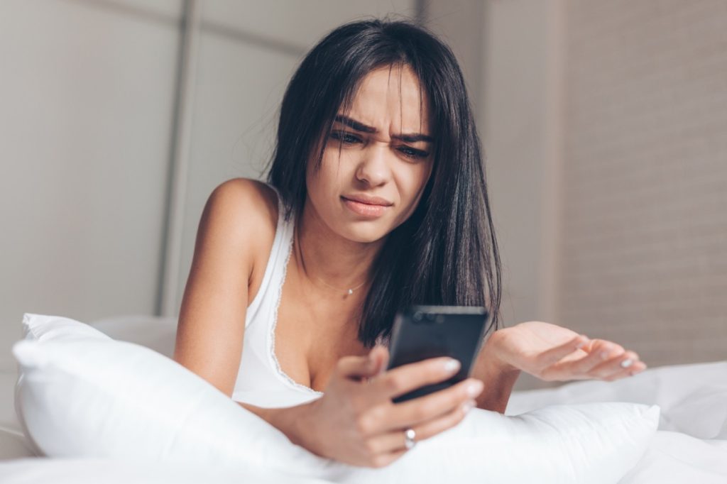 woman looking confused at phone