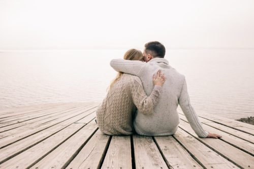 couple sitting together on dock